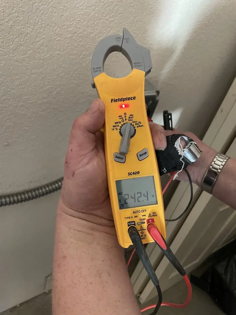 Voltage testing with clamp meter during Outlet Installation in Port Jefferson